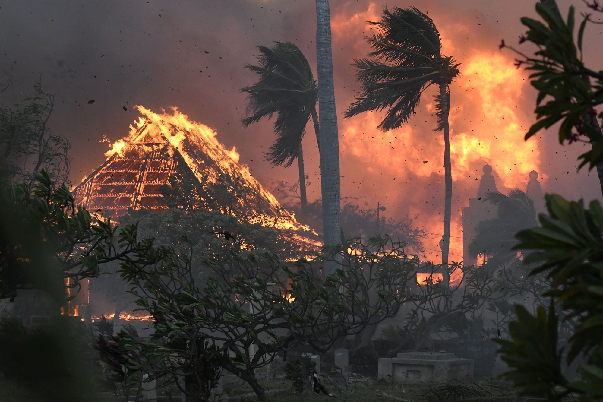 The hall of historic Waiola Church in Lahaina and nearby Lahaina Hongwanji Mission are engulfed in flames on Aug. 8, 2023. (Matthew Thayer/The Maui News via AP)